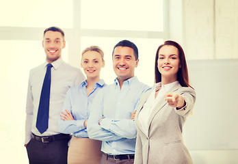 Image showing businesswoman in office pointing finger at you