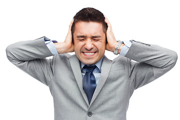 Image showing businessman in suit having head ache