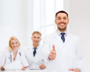 Image showing smiling male doctor showing thumbs up