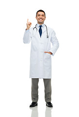 Image showing happy male doctor in white coat pointing finger up