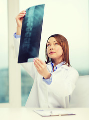 Image showing concentrated doctor looking at x-ray