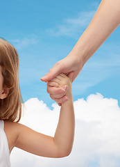 Image showing close up of woman and little girl holding hands