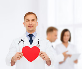 Image showing smiling male doctor with red heart and stethoscope