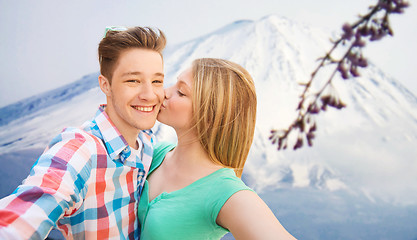 Image showing smiling couple with smartphone in city