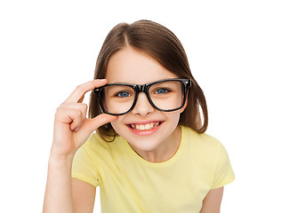 Image showing smiling cute little girl in black eyeglasses