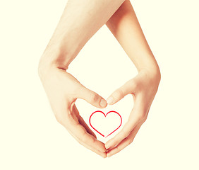 Image showing woman and man hands showing heart shape