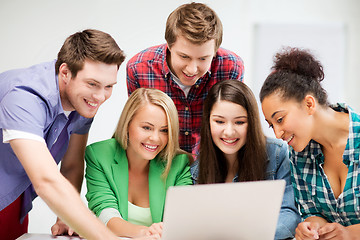 Image showing international students looking at laptop at school