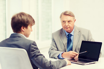 Image showing older man and young man with laptop computer