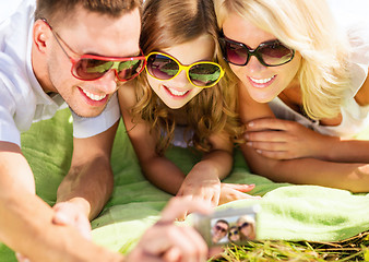 Image showing happy family with camera taking picture