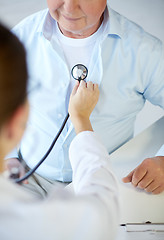 Image showing close up of doctor with stethoscope and senior man