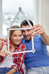 Image showing close up of couple with house shape ruler