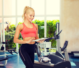 Image showing smiling sporty woman with tablet pc computer