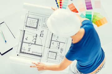 Image showing woman with color samples and blueprint