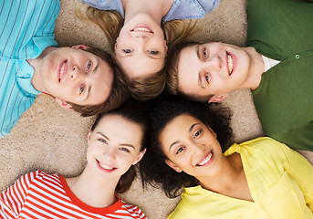 Image showing group of smiling people lying down on floor