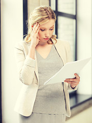 Image showing worried woman with documents