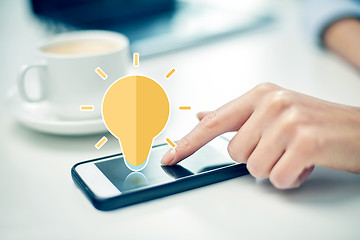 Image showing close up of woman hand with smartphone and coffee