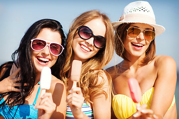 Image showing girls in bikinis with ice cream on the beach