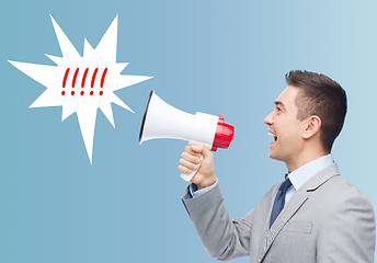 Image showing happy businessman in suit speaking to megaphone