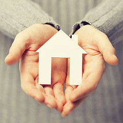 Image showing man holding paper house