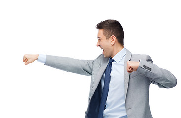 Image showing businessman in suit fighting with someone