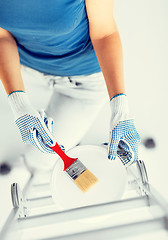 Image showing woman with paintbrush and paint pot