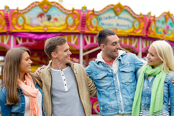 Image showing group of smiling friends in amusement park