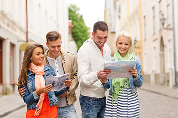 Image showing group of smiling friends with city guide and map