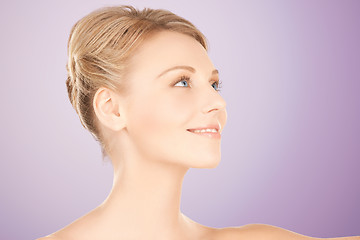 Image showing beautiful young woman face over violet background