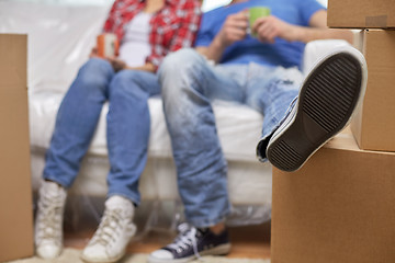 Image showing close up of couple relaxing on sofa in new home