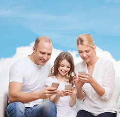 Image showing happy family with smartphones