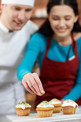 Image showing happy woman and chef cook baking in kitchen