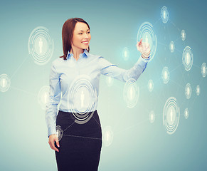 Image showing smiling businesswoman working with virtual screen