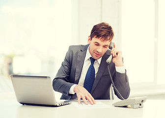 Image showing businessman with laptop computer and phone