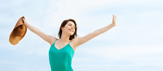 Image showing girl in hat standing on the beach