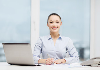 Image showing businesswoman with phone, laptop and files
