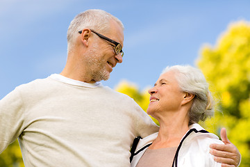 Image showing senior couple hugging in city park