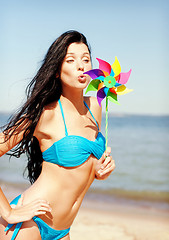 Image showing girl with windmill toy on the beach