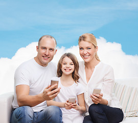 Image showing happy family with smartphones