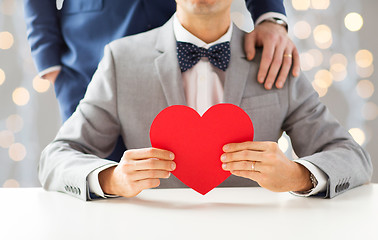 Image showing close up of male gay couple with red heart