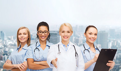 Image showing smiling female doctor and nurses with stethoscope