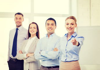 Image showing businesswoman in office pointing finger at you