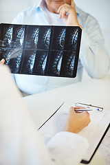 Image showing close up of senior patient and doctor with x-ray