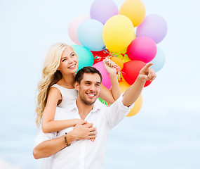 Image showing couple with colorful balloons at sea side