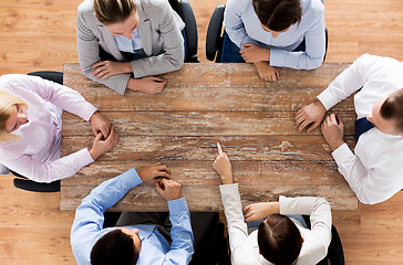 Image showing close up of business team sitting at table