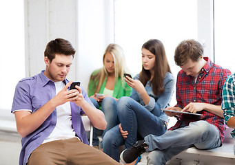 Image showing students looking into devices at school
