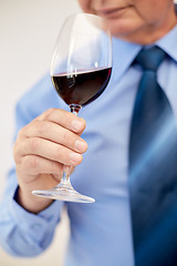 Image showing close up of senior man drinking wine from glass