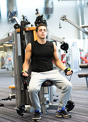 Image showing man exercising on gym machine