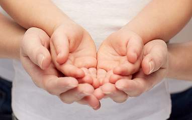 Image showing close up of woman and girl with cupped hands