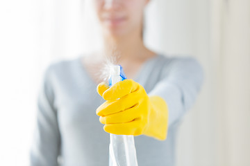 Image showing close up of happy woman with cleanser spraying