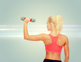 Image showing young sporty woman with light dumbbell